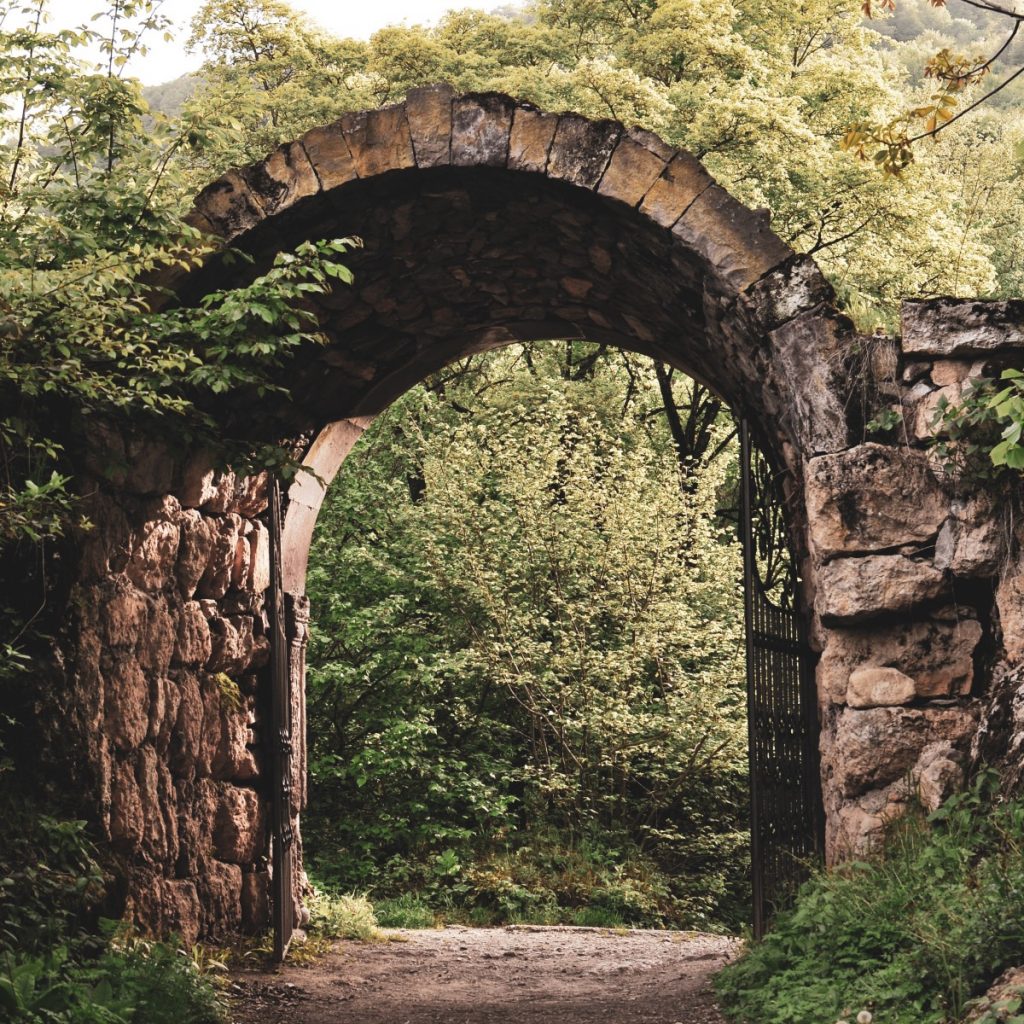 old stone arch with gate open